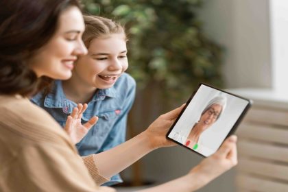 Adult child on video call with elderly parent - long-distance caregiving support