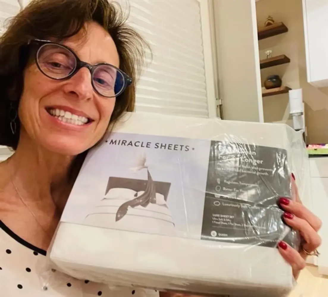 Miracle Sheets customer review - senior holding Miracle Sheets package