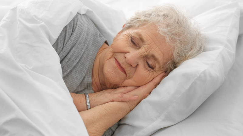 Elderly woman sleeping peacefully - best sleep aids for seniors