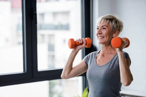 senior woman doing resistance exercises with dumbbells